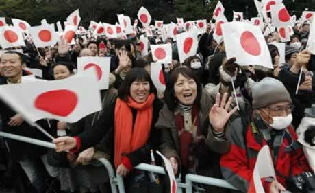 Well-wishers wave Japanese flags as Japan's Emperor Akihito makes a public appearance on a balcony of the Imperial Palace in Tokyo. (AP Photo/Shizuo Kambayashi)